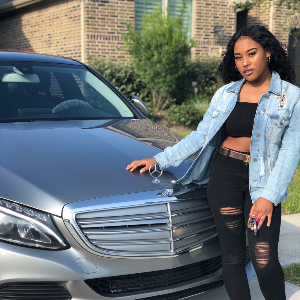 Tae Caldwell showing off her car