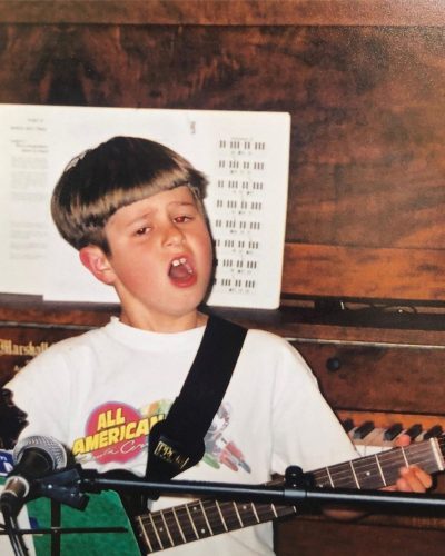 Oliver Tree playing guitar when he was a kid